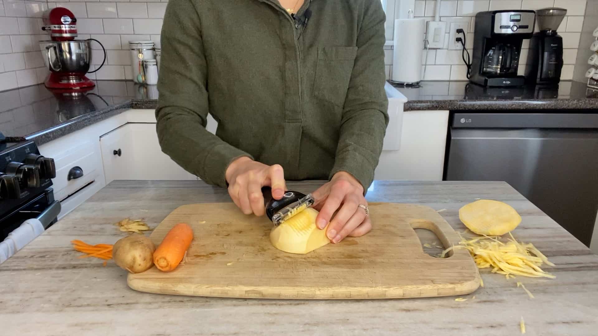 woman slicing a rutabaga with a julienne peeler on a bamboo cutting board