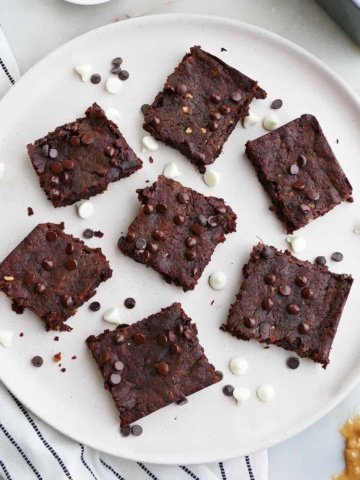 square image of 7 sweet potato brownies on a serving plate with chocolate chips