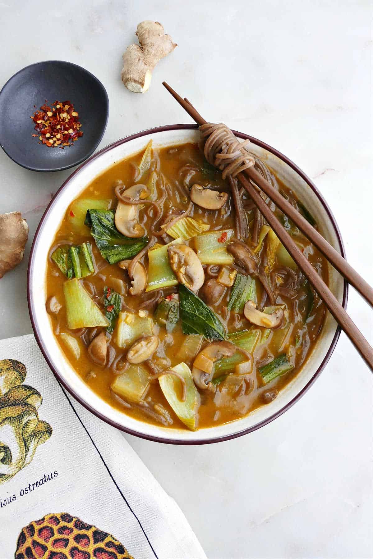 bok choy miso soup in a soup bowl with chopsticks on the edge on a counter