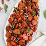 spiced carrots and dates on an oval serving dish on a counter