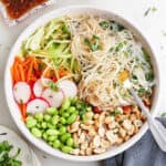 deconstructed spring roll in a bowl with toppings on a counter