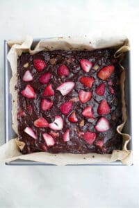 strawberry rhubarb brownies in a square pan before baking