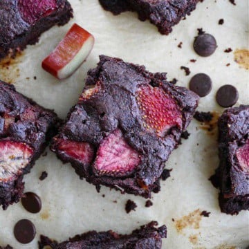 close-up photo of a strawberry rhubarb brownie surrounded by more brownies