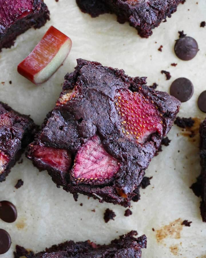 close-up photo of a strawberry rhubarb brownie surrounded by more brownies