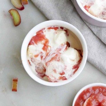 small bowl of vanilla ice cream with rhubarb sauce on a counter