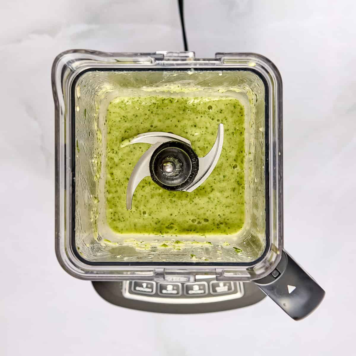 Celery smoothie blended in a blender.