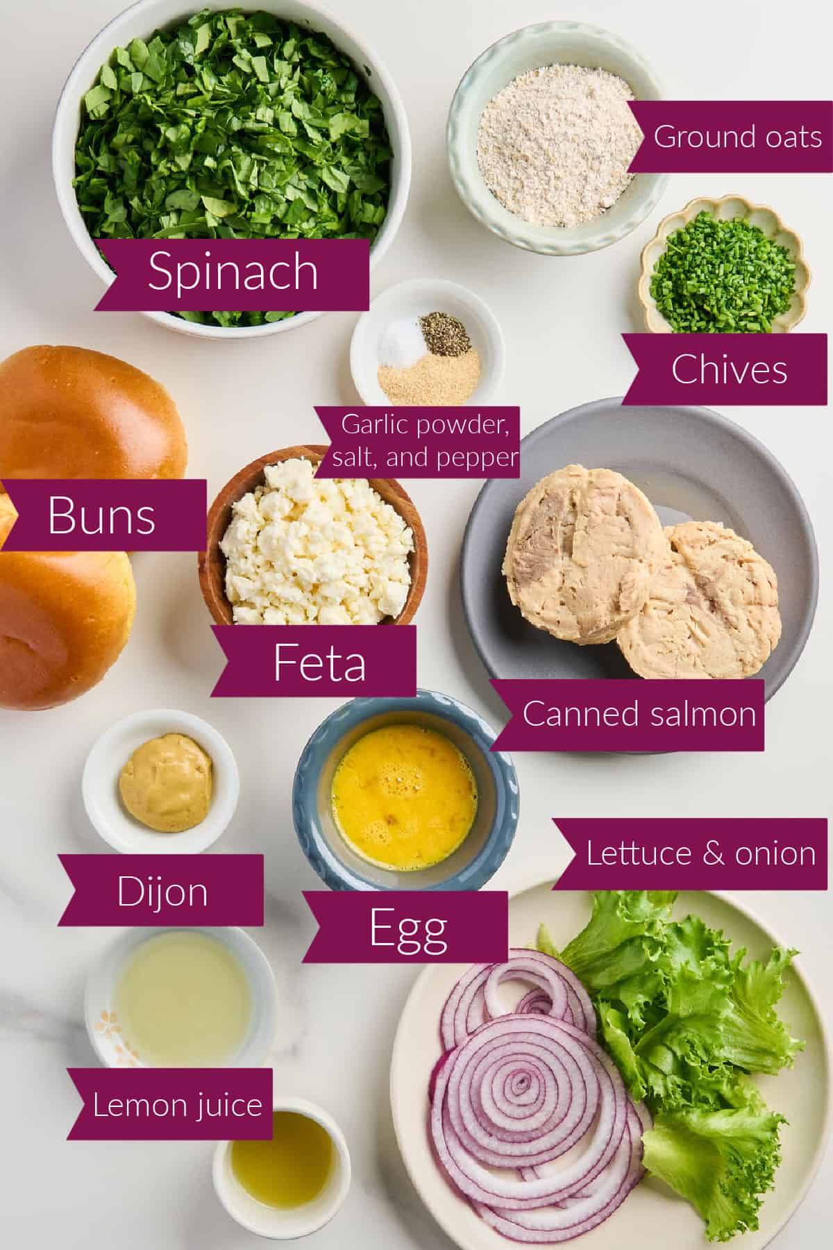Spinach, oats, chives, spices, bun, feta, salmon, Dijon, egg, lemon juice, oil, onion, lettuce with labels.