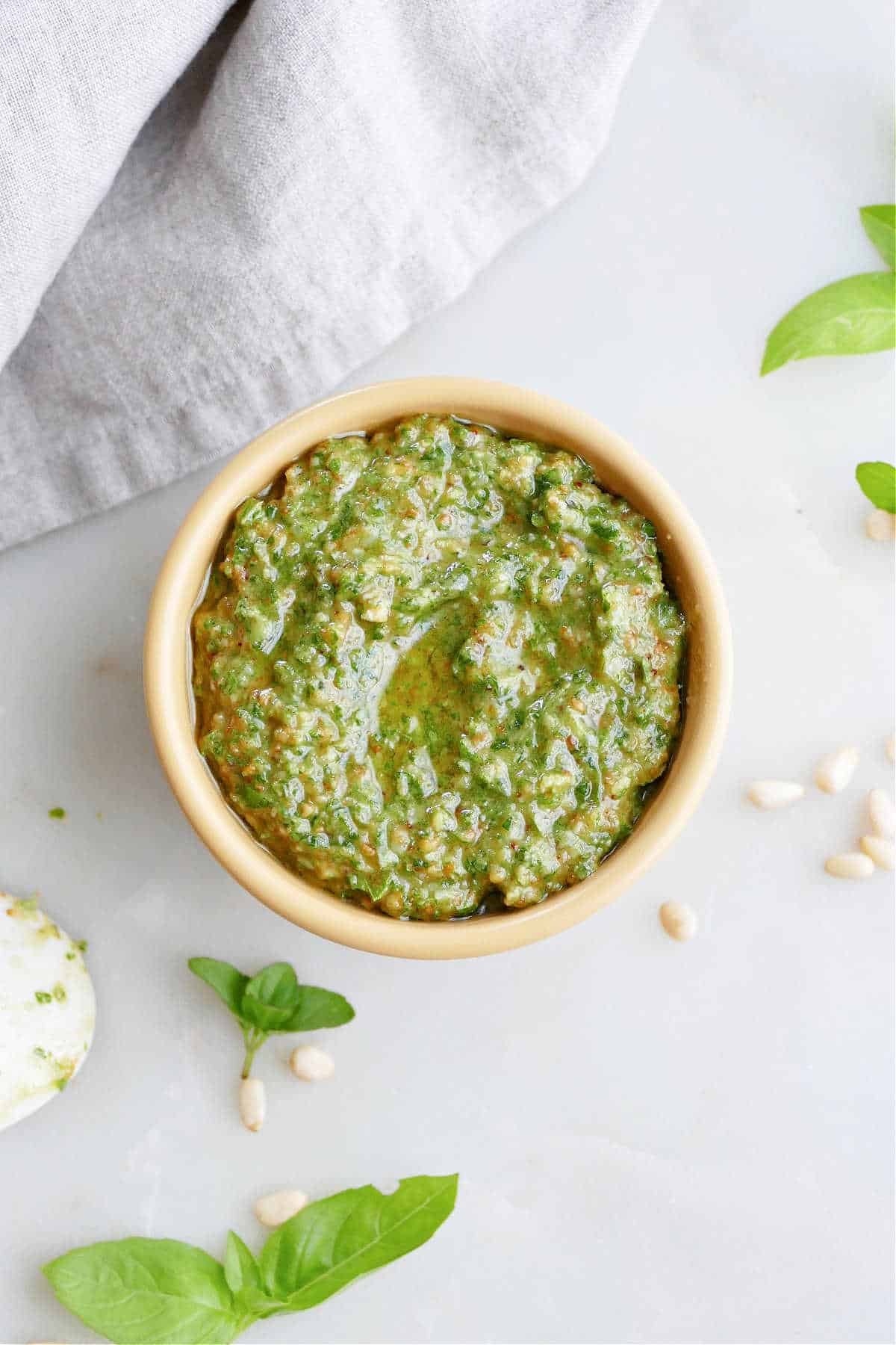 mint basil pesto in a small bowl on a counter next to a napkin