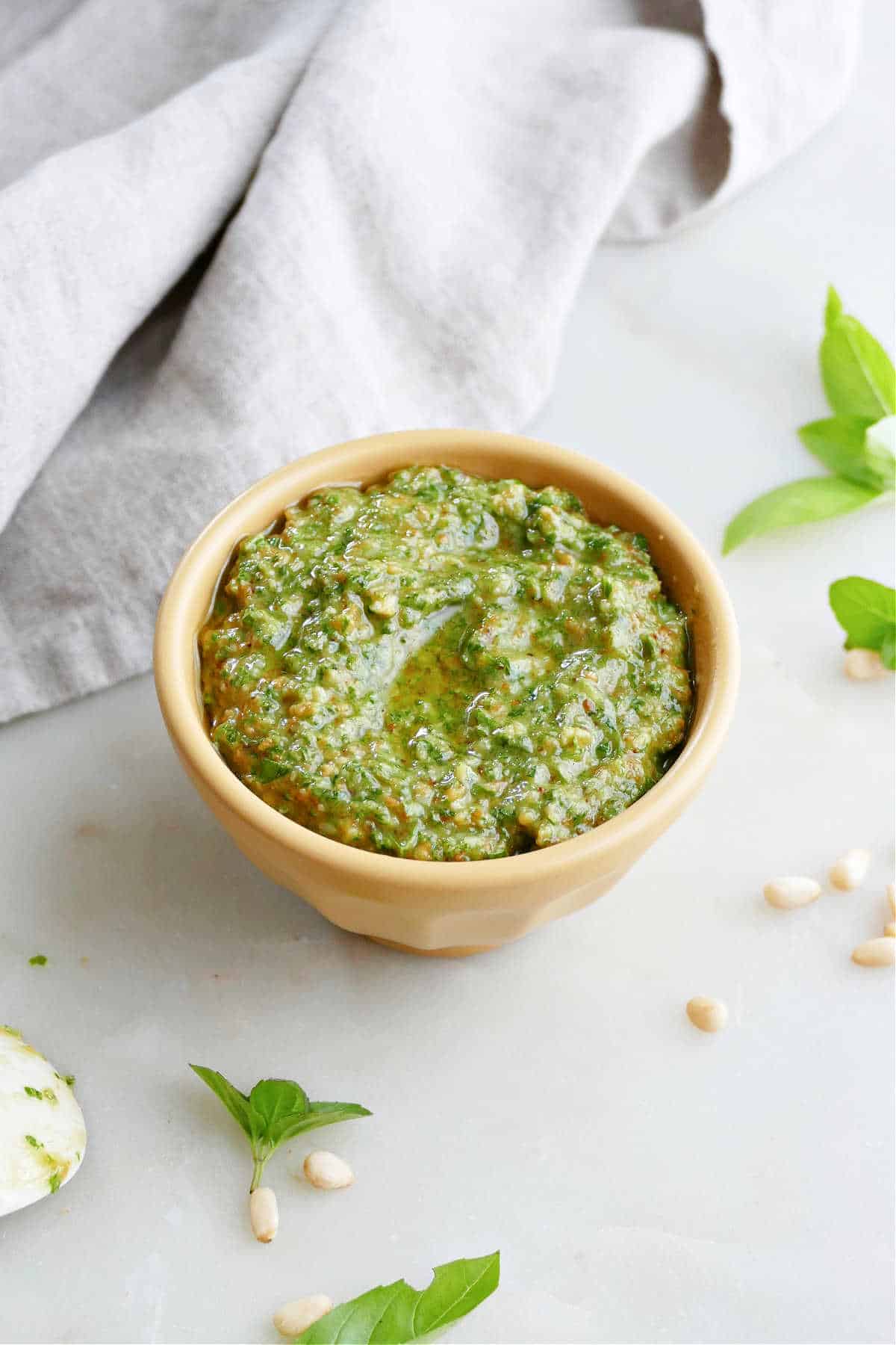 mint basil pesto in a small bowl on a counter next to a napkin