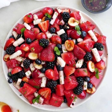 red, white, and blue fruit salad on a large serving dish on a counter