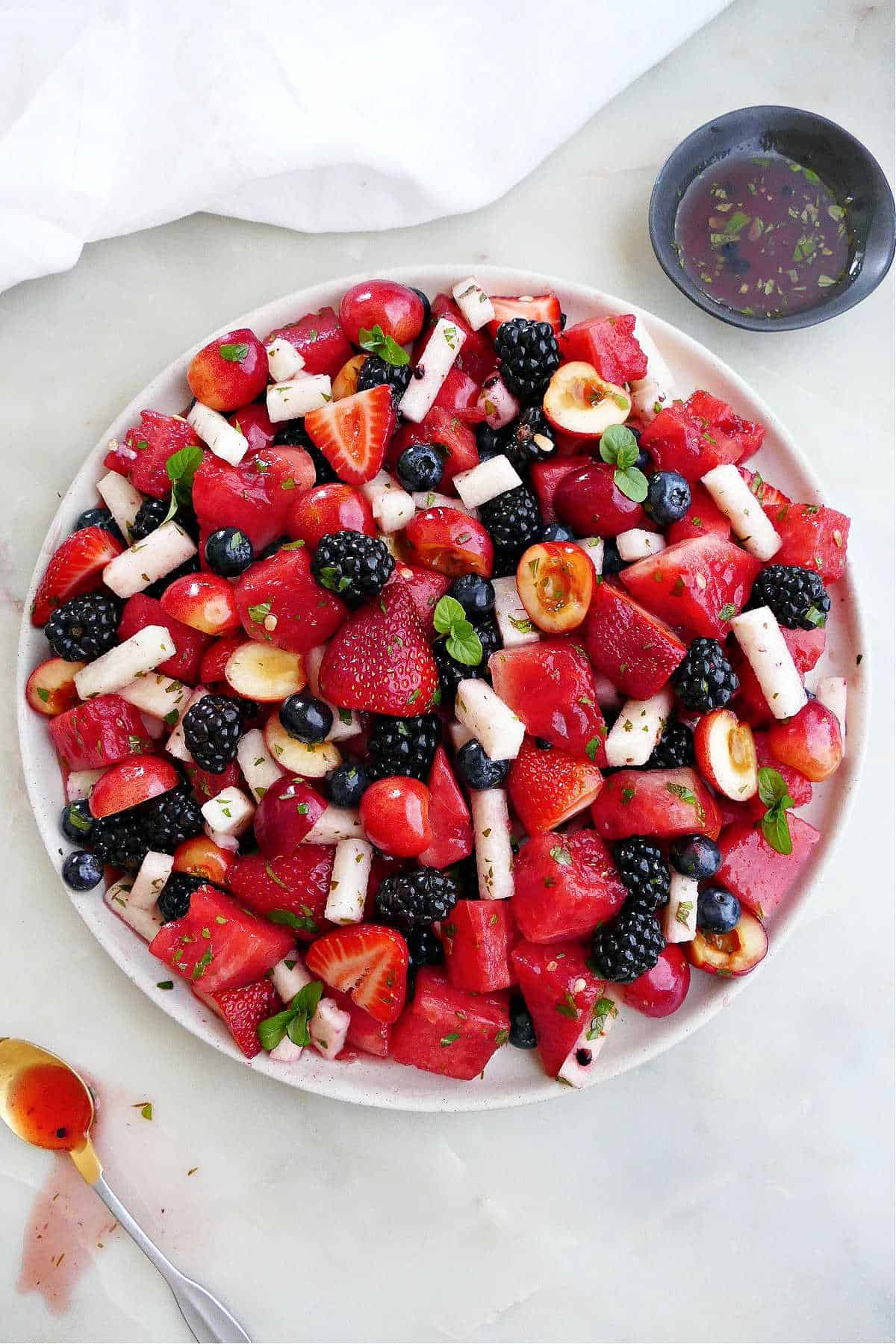 red, white, and blue fruit salad on a large serving dish on a counter