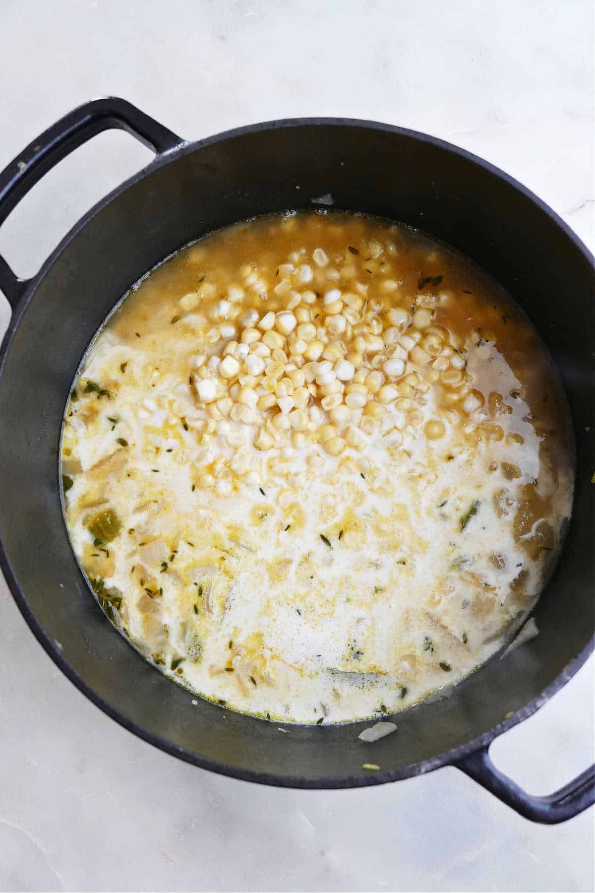 sweet corn soup cooking in a large Dutch oven sitting on a counter