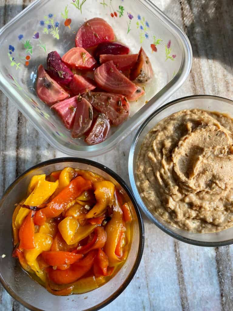 slow cooker beets, onion dip, and roasted red peppers spread out on a counter