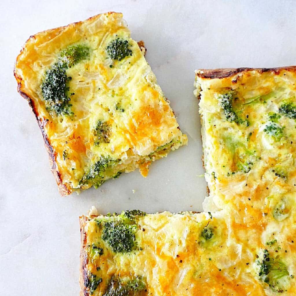 broccoli and cheese egg bake on a counter with one slice cut