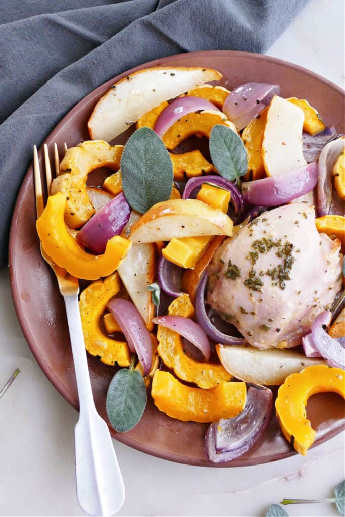 sheet pan winter squash and chicken on a plate with a fork