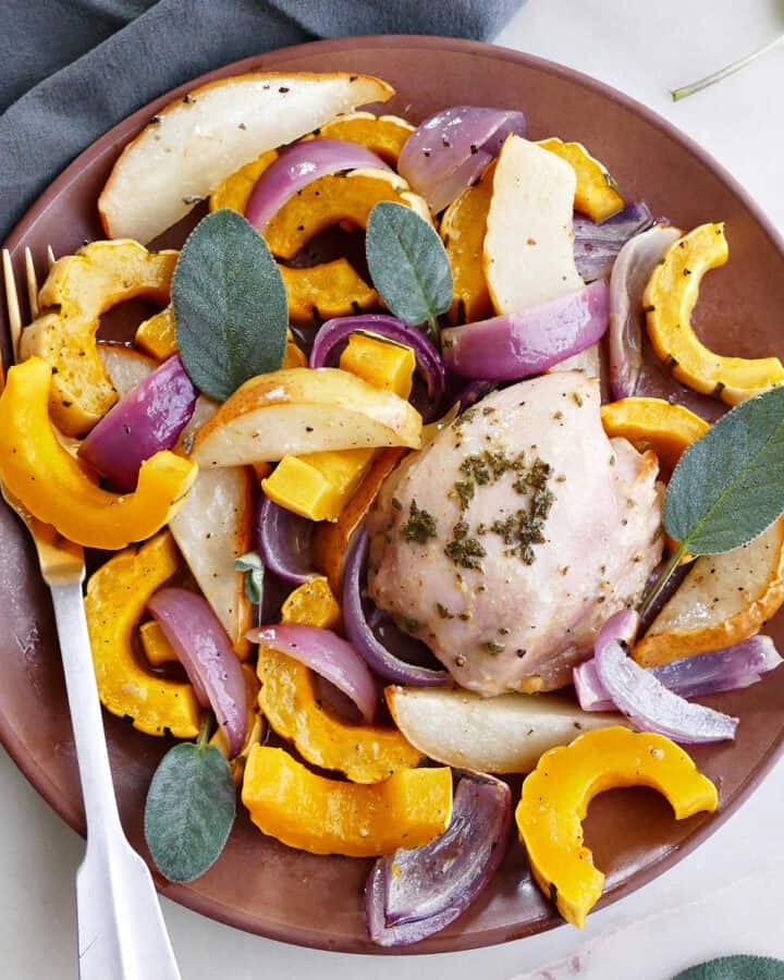 delicata squash and chicken meal on a serving plate with a fork and sage leaves