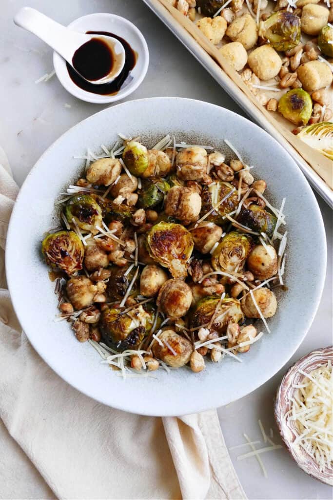 gnocchi, Brussels sprouts, white beans, parmesan, and balsamic reduction in a serving bowl