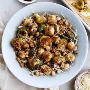 gnocchi, Brussels sprouts, white beans, parmesan, and balsamic reduction in a serving bowl