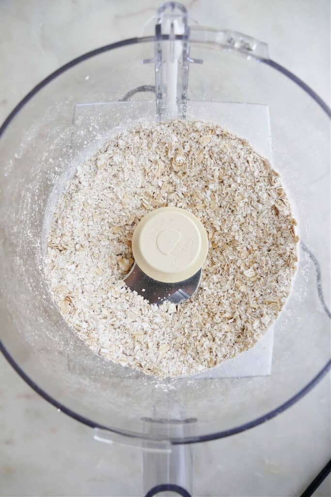 old fashioned oats being ground into a flour in a food processor