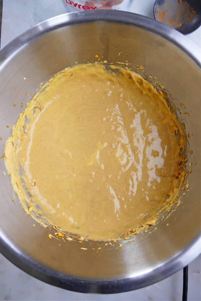 pumpkin cheesecake filling in a mixing bowl on a counter
