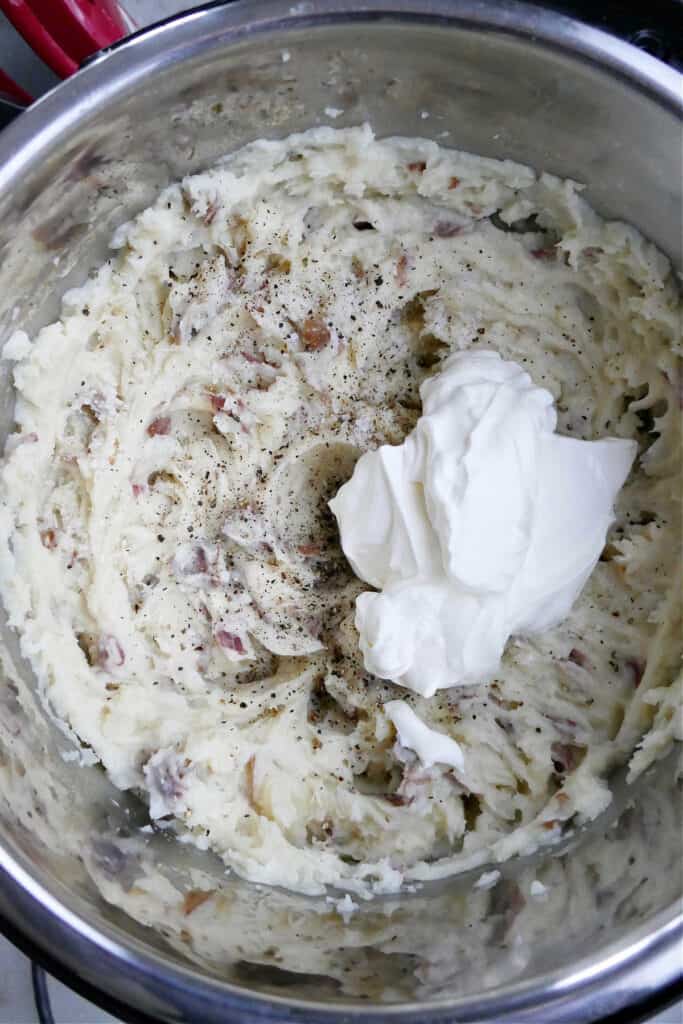 mashed red potatoes blended and topped with sour cream in a pressure cooker