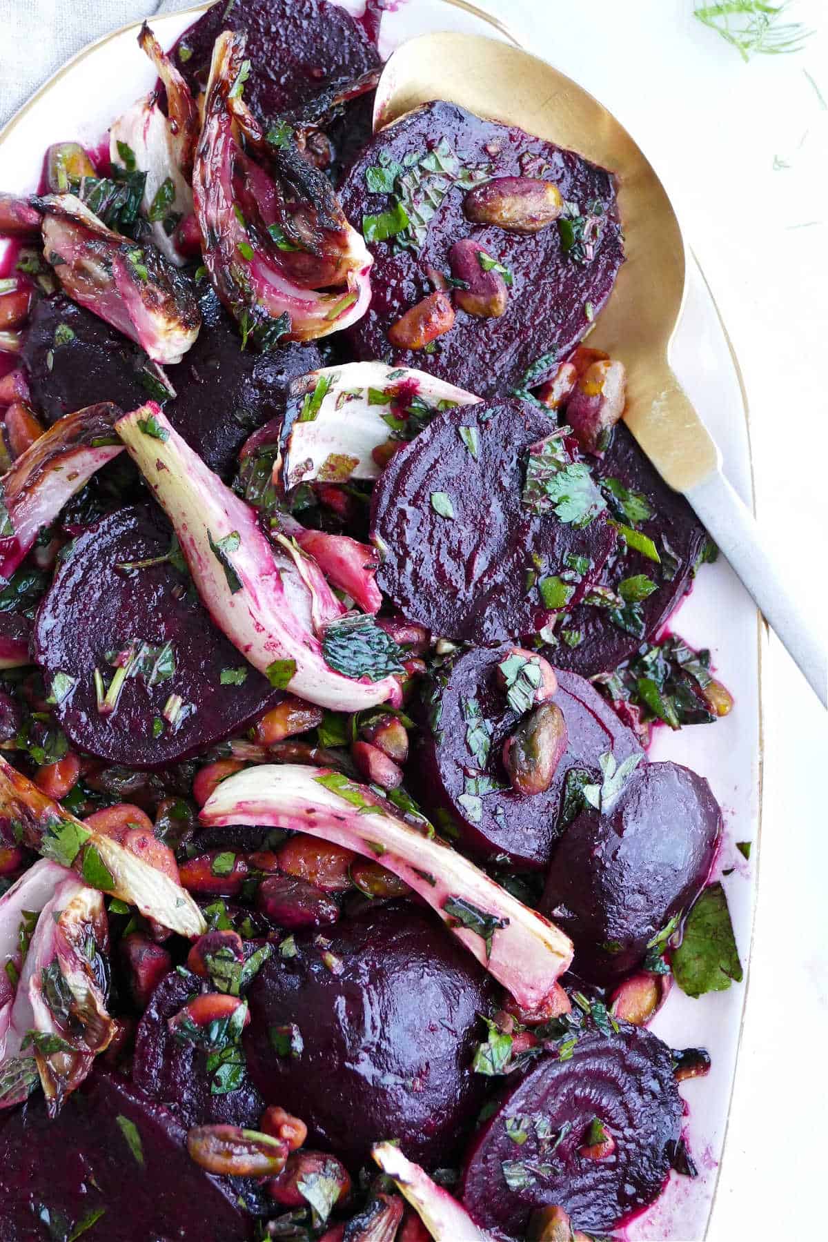 beet fennel salad with herbs and citrus dressing on a serving dish