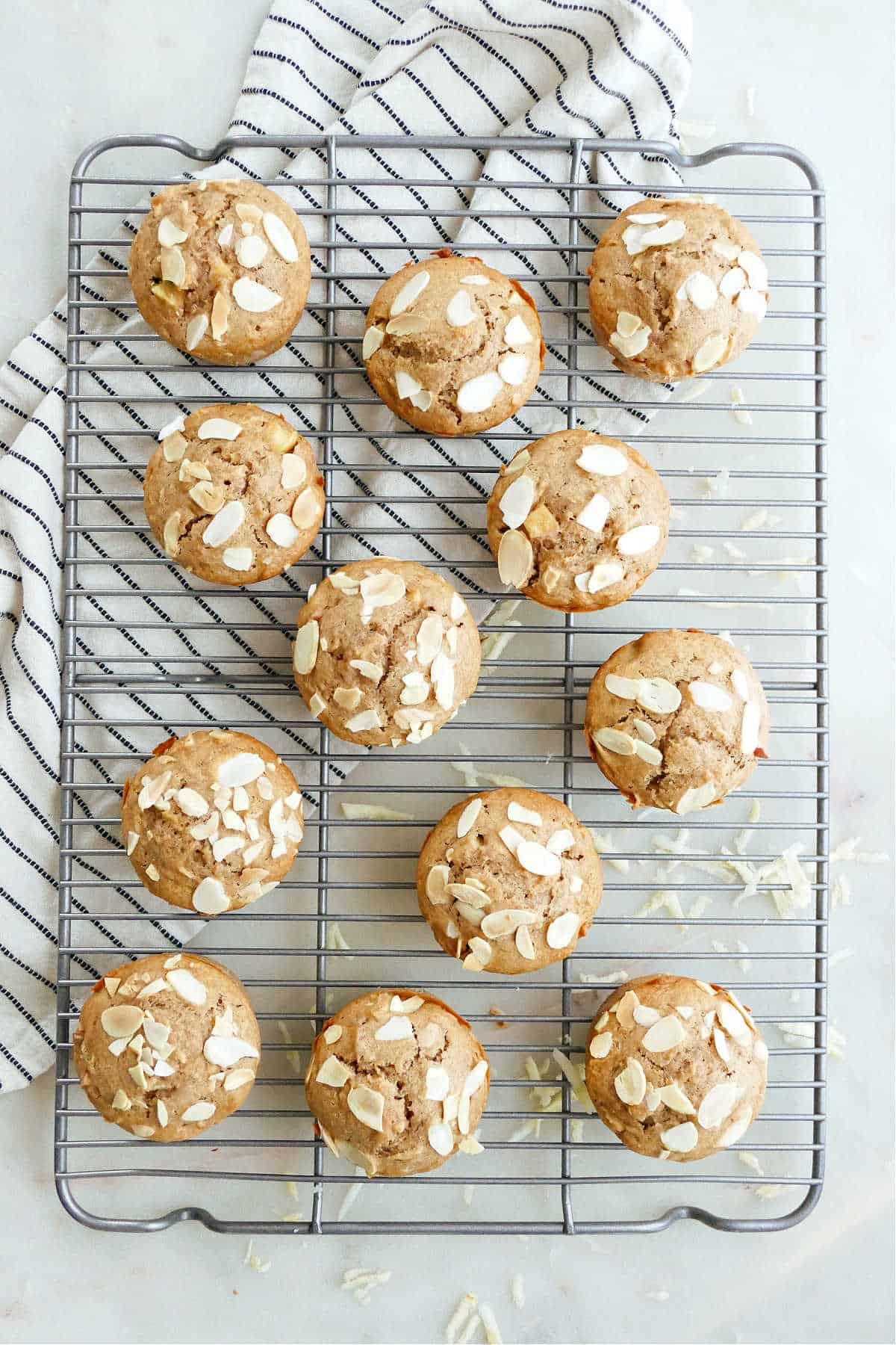 12 apple parsnip muffins on a wire cooling rack on top of a counter