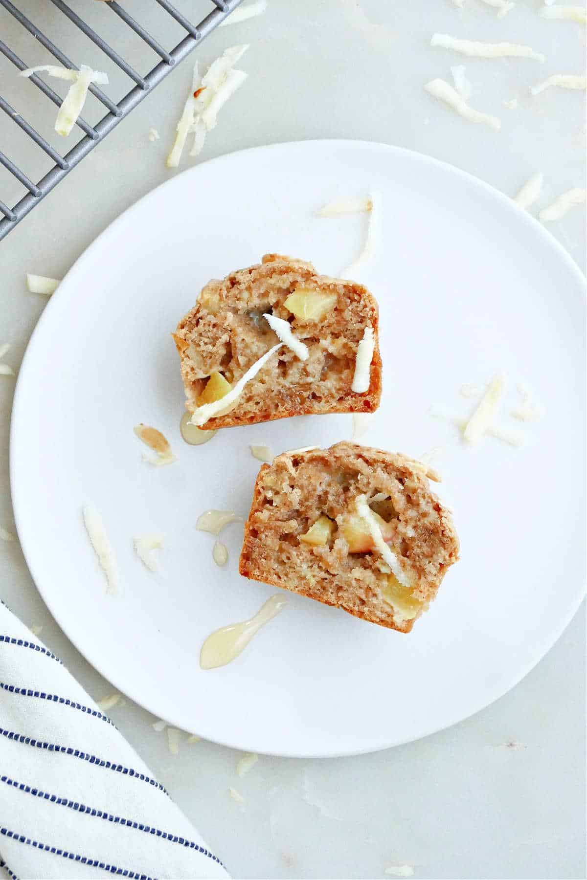 one apple parsnip muffin sliced in half and drizzled with honey on a serving plate