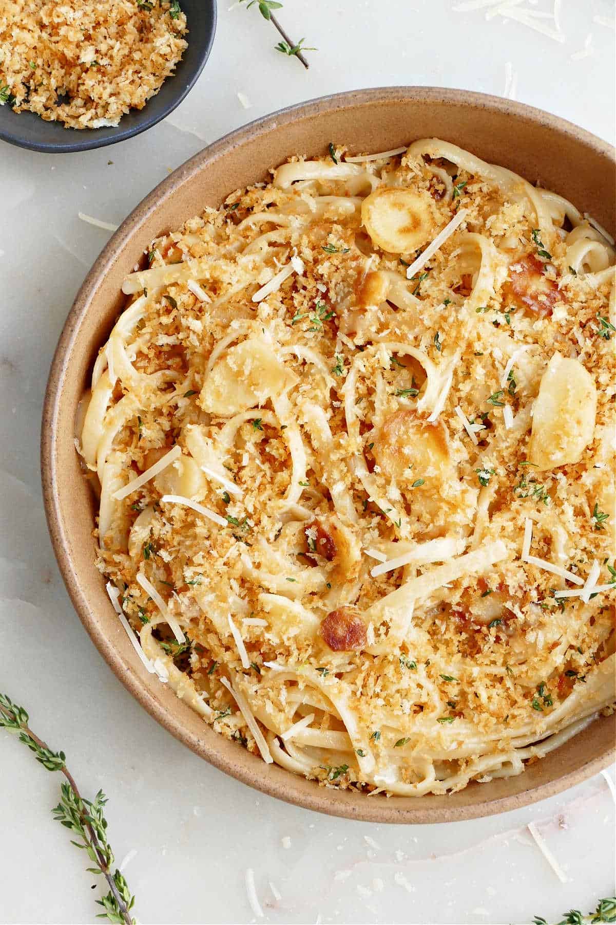 parsnip pasta and garlic thyme breadcrumbs in a serving bowl on a counter