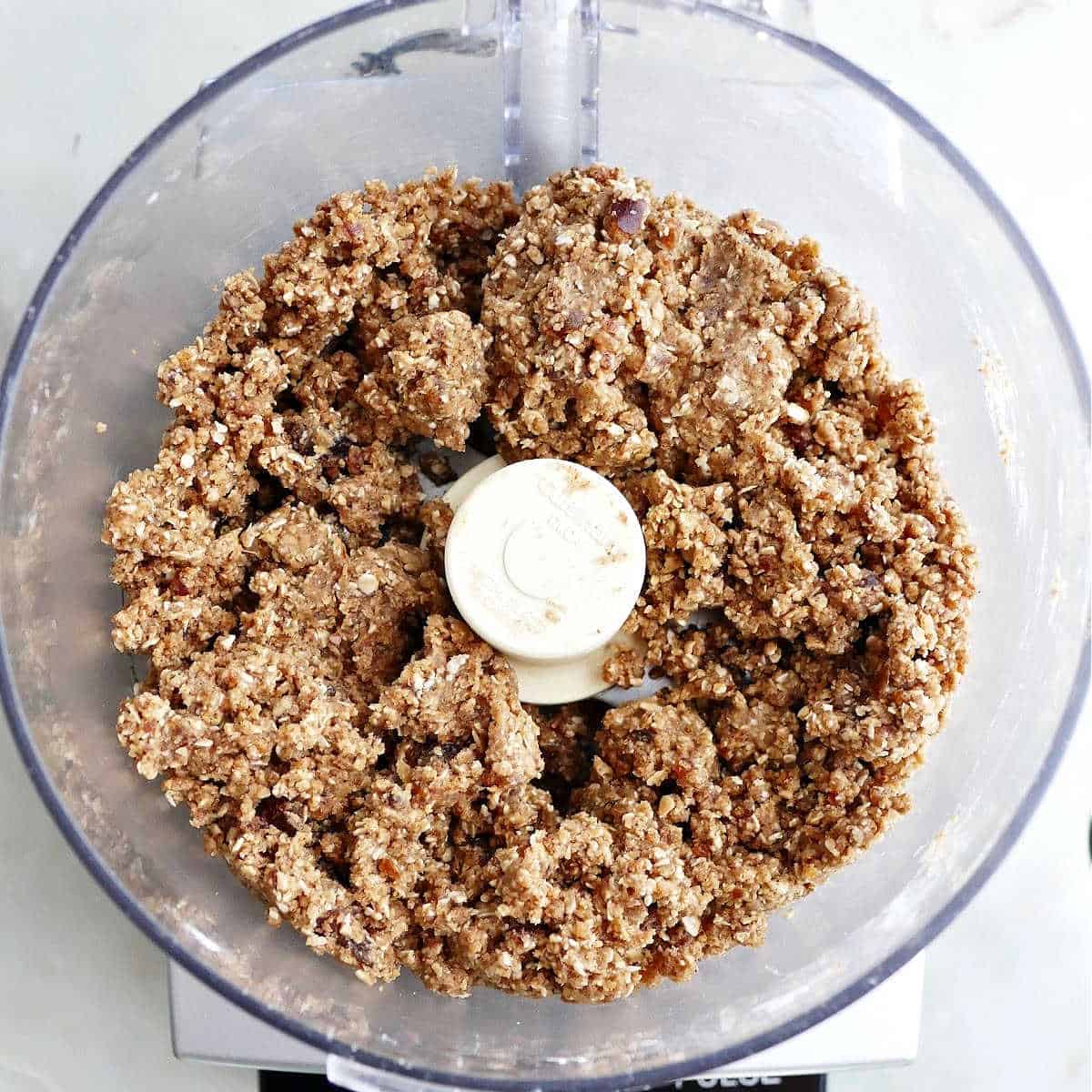 batter for almond butter oatmeal bars being mixed in a food processor on a counter