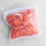 frozen sweet potato cubes in a reusable silicone bag on a counter