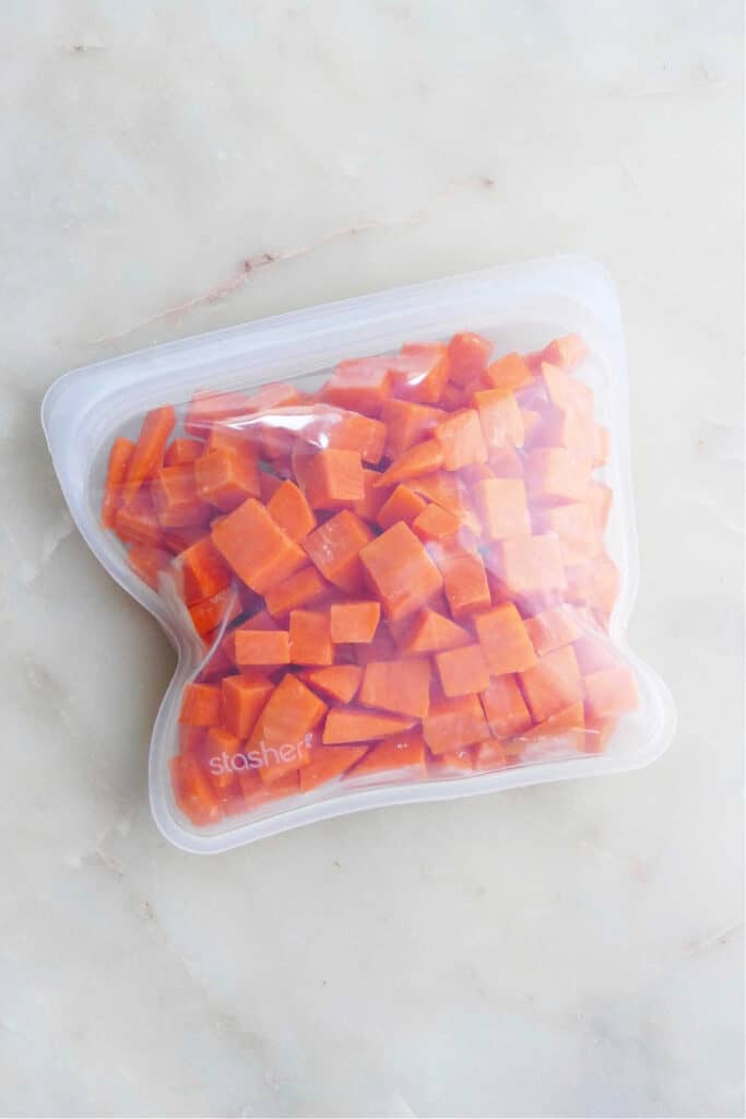 frozen sweet potato cubes in a reusable silicone bag on a counter