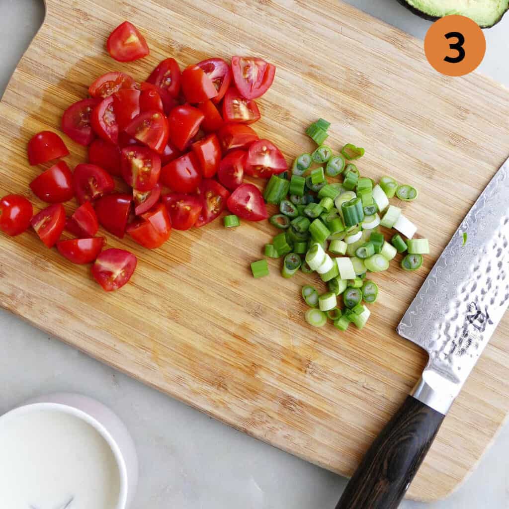 chopped tomatoes and green onions on a board with number 3 in top right corner