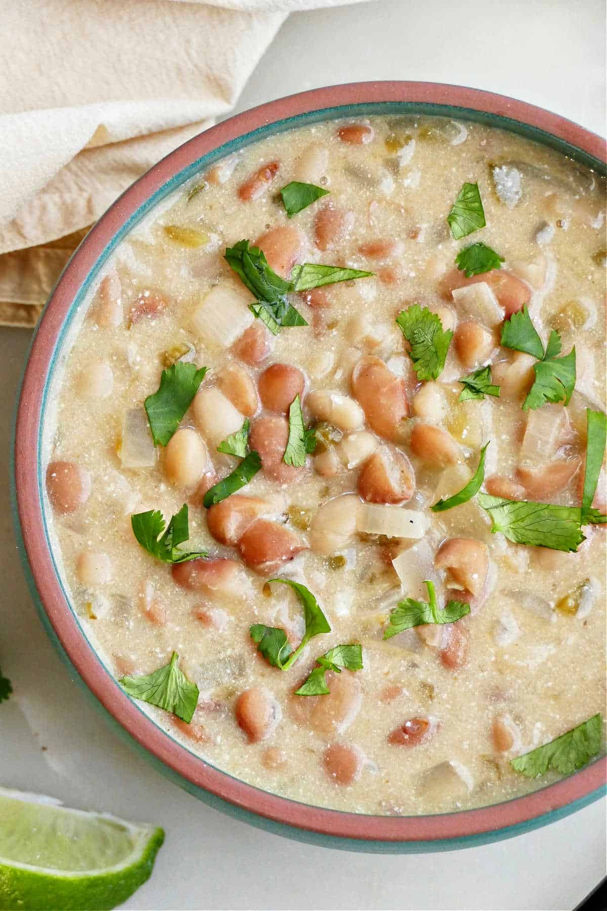 creamy meatless white chili topped with chopped cilantro in a serving bowl
