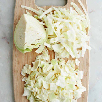 cabbage sliced into different shapes on a bamboo cutting board