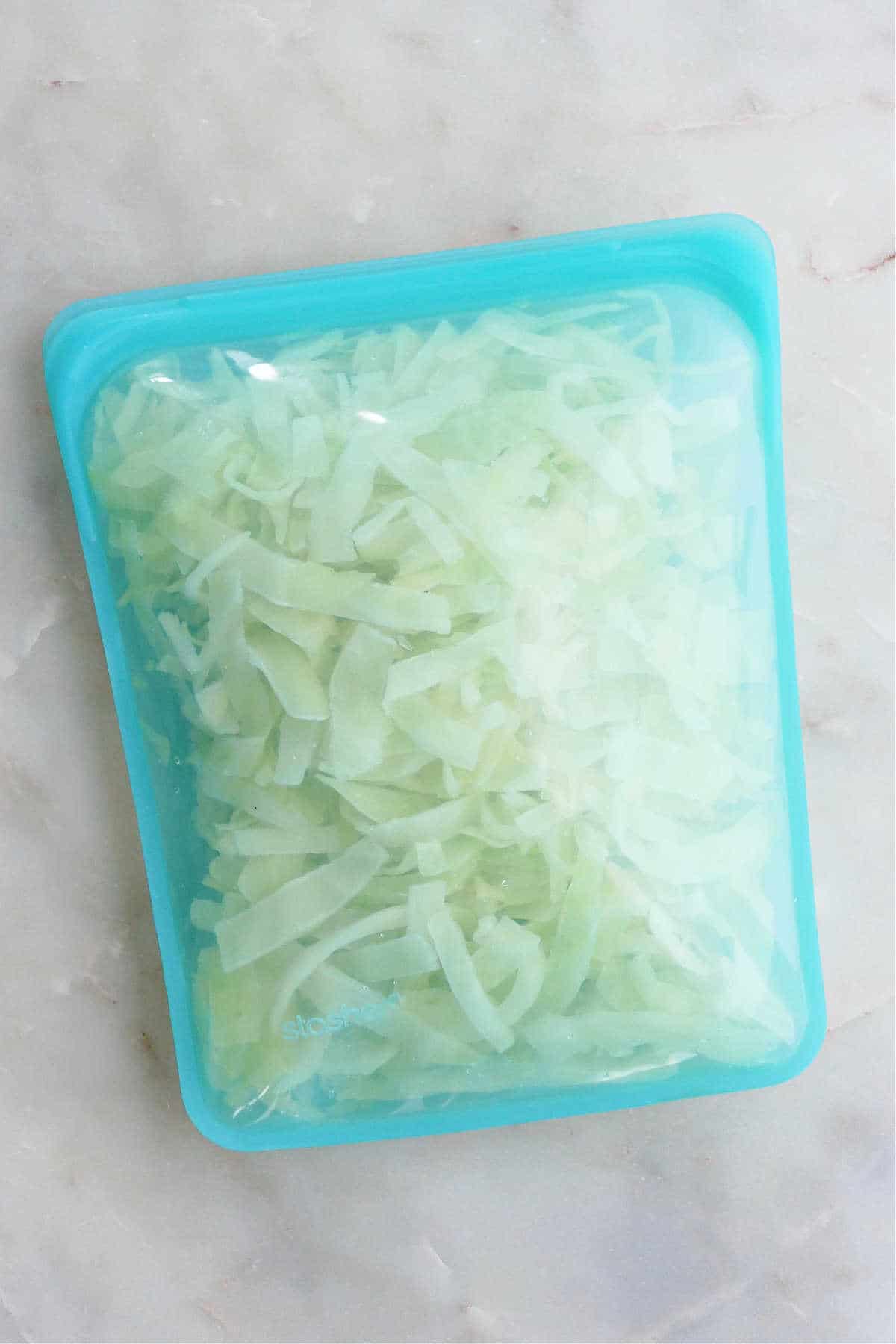 shredded cabbage in a freezer bag on a counter before going into the freezer