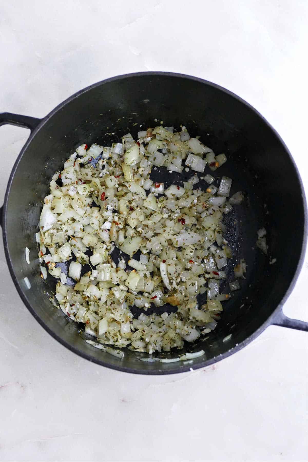 garlic, onions, and seasonings cooking in olive oil in a soup pot