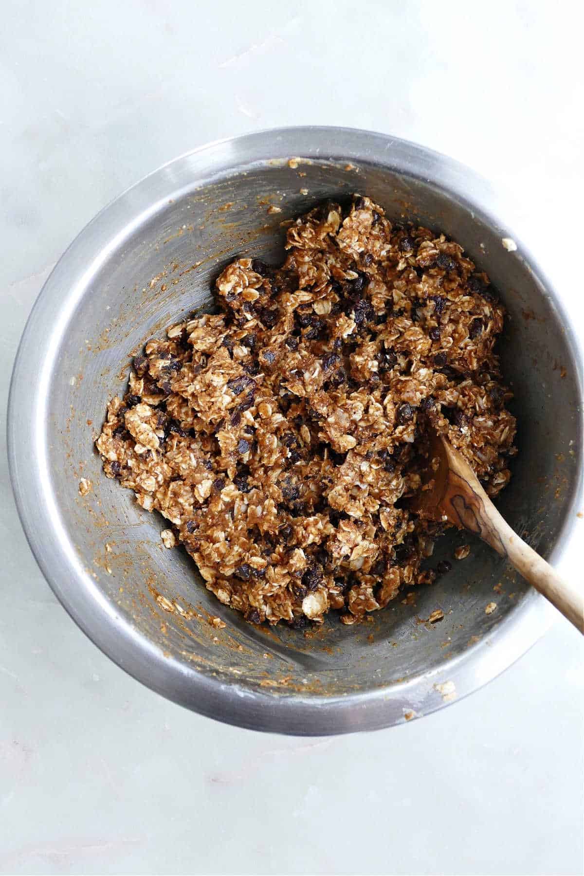 ingredients for almond butter energy balls mixed together in a large bowl