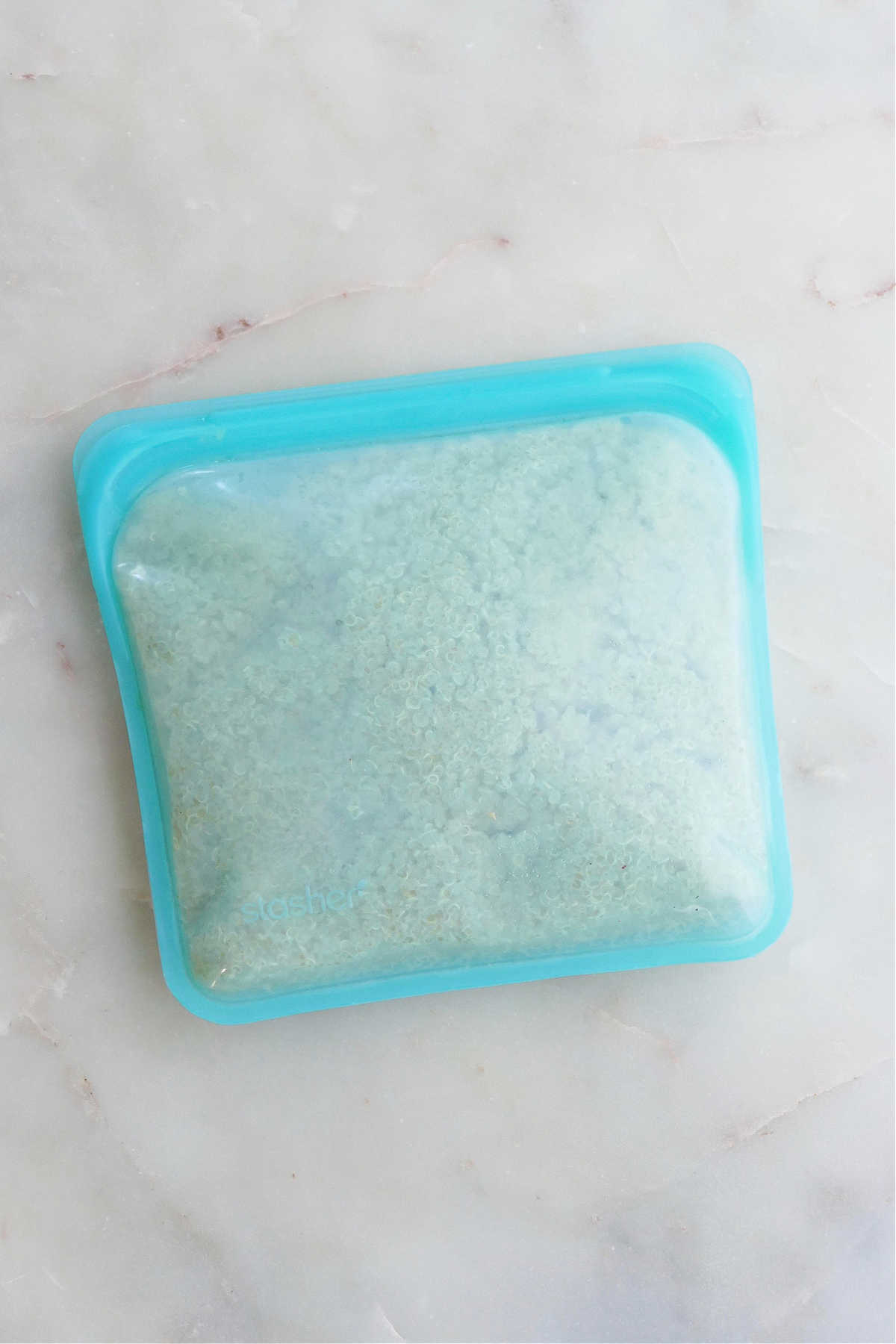 cooked quinoa in a reusable silicone Stasher bag on a counter