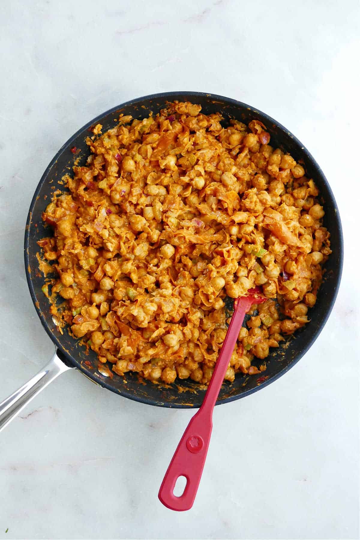 buffalo chickpea filling for sweet potatoes cooking in a skillet