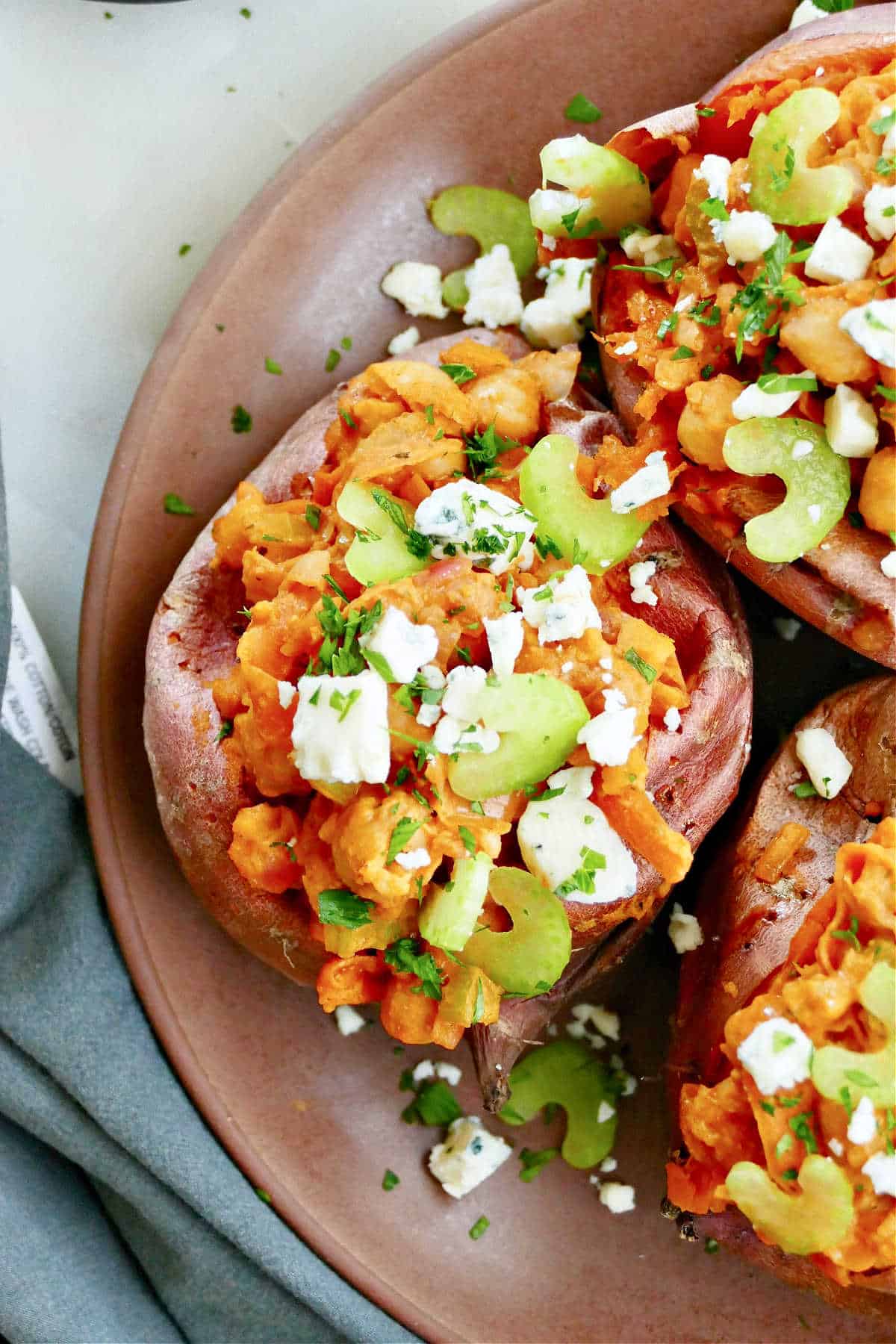 buffalo chickpea stuffed sweet potato topped with celery and blue cheese