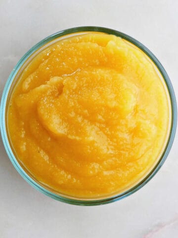 acorn squash puree in a glass bowl on a counter