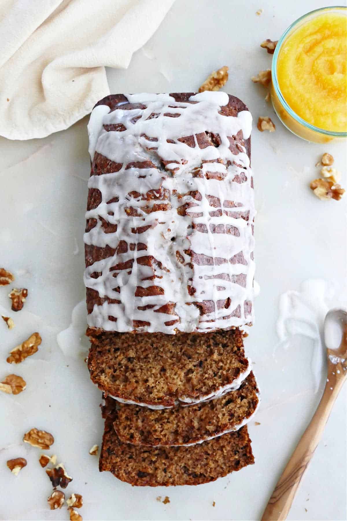 loaf of acorn squash bread on a counter with three slices cut off the bottom