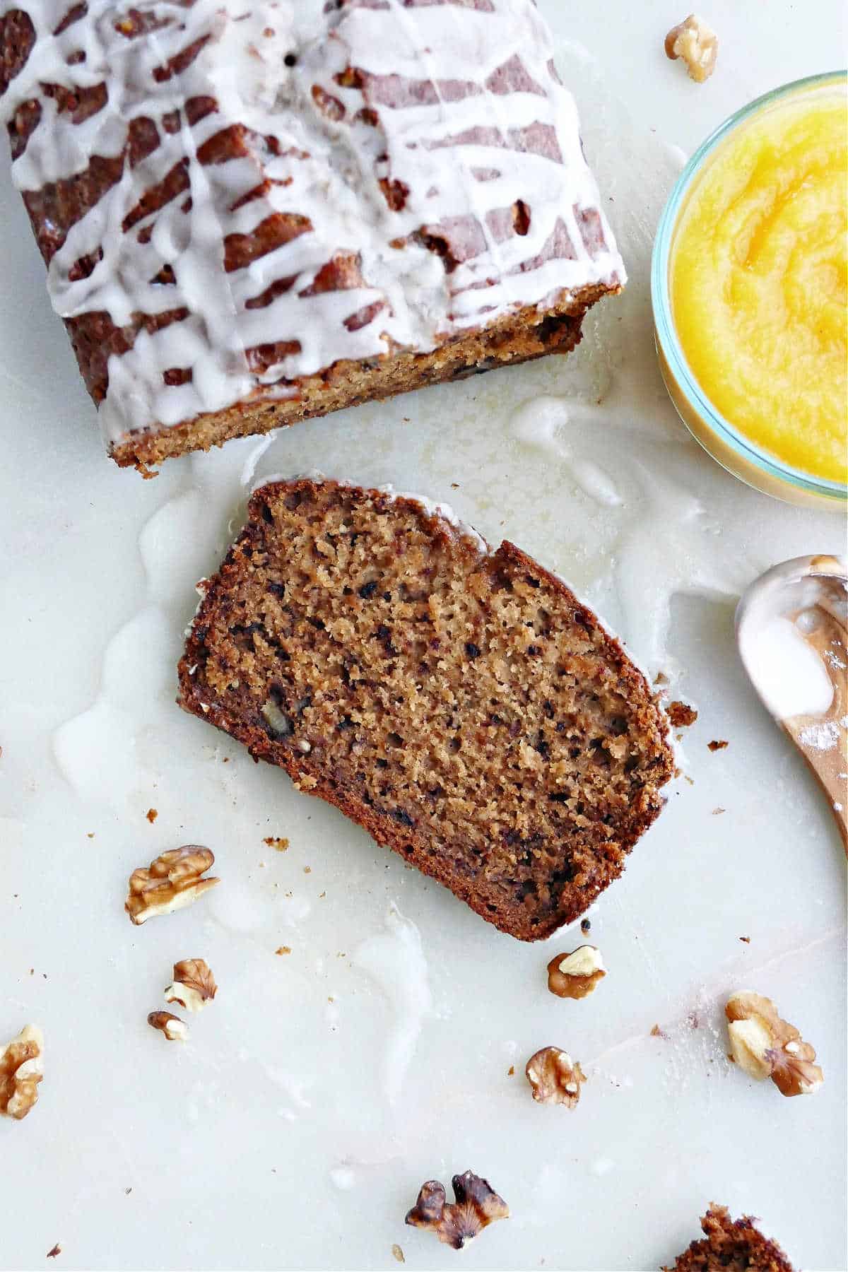 slice of acorn squash bread on a counter next to loaf and ingredients