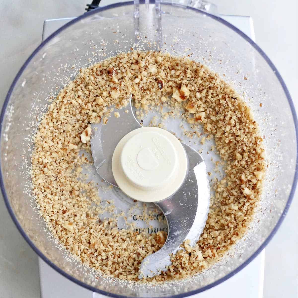 ground walnuts in a food processor on a counter