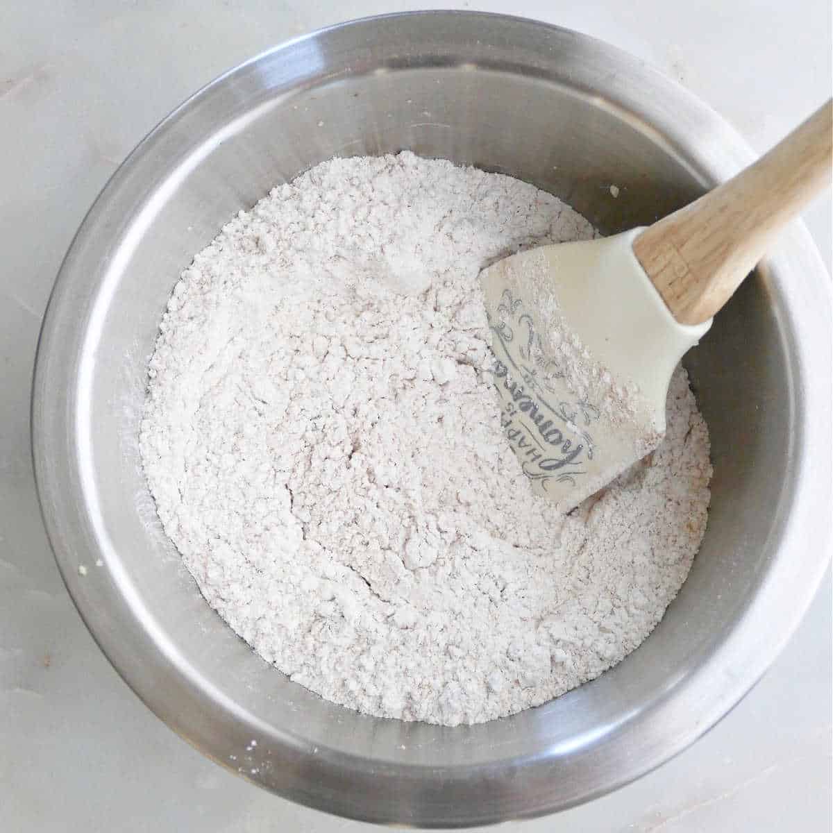 mixing bowl with flour, seasonings, and ground walnuts on a counter