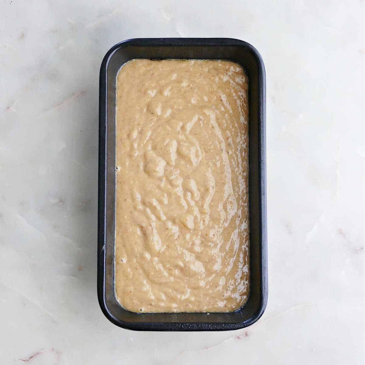 batter for squash bread in a loaf pan before baking
