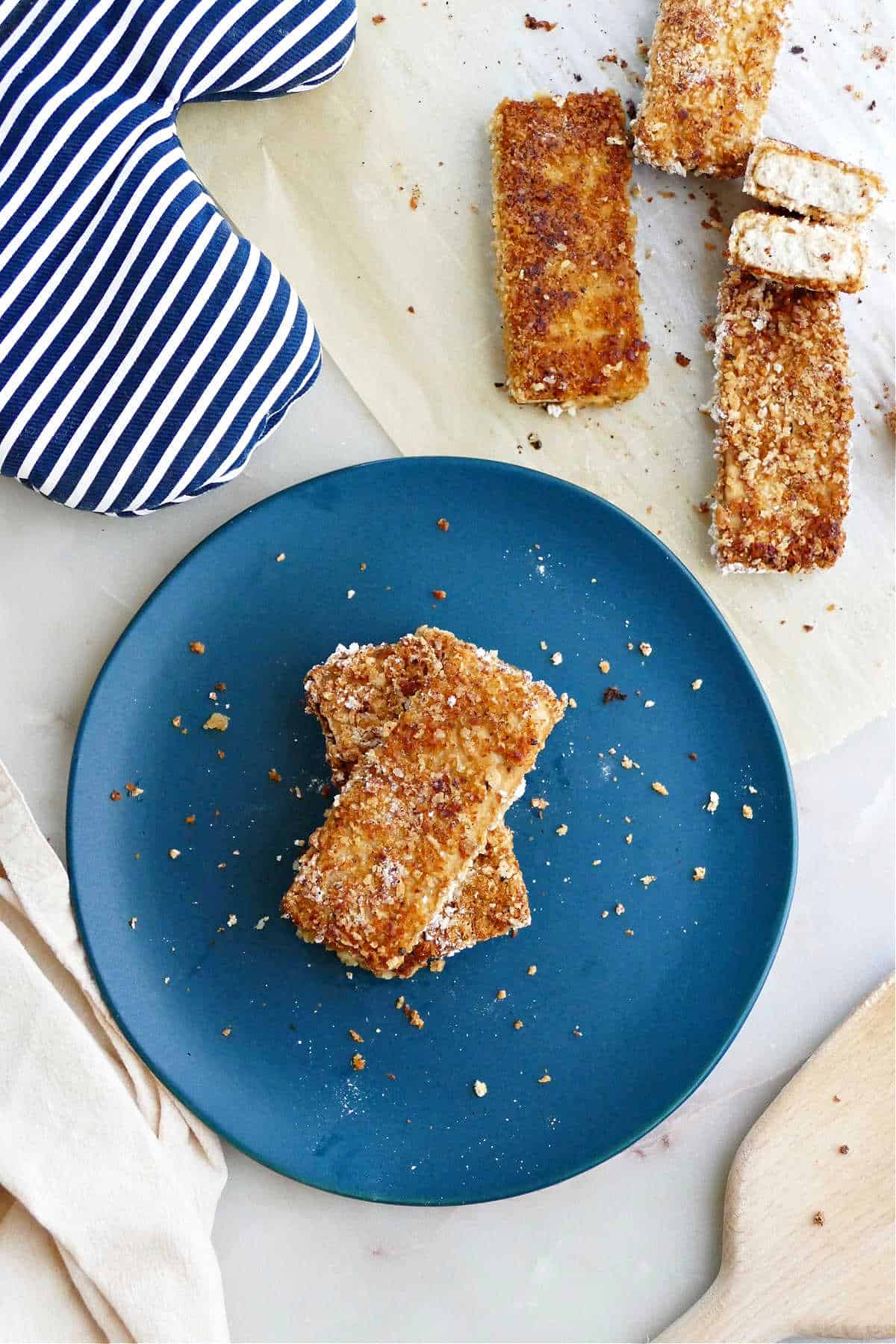 crispy panko tofu pieces stacked on top of each other on a plate