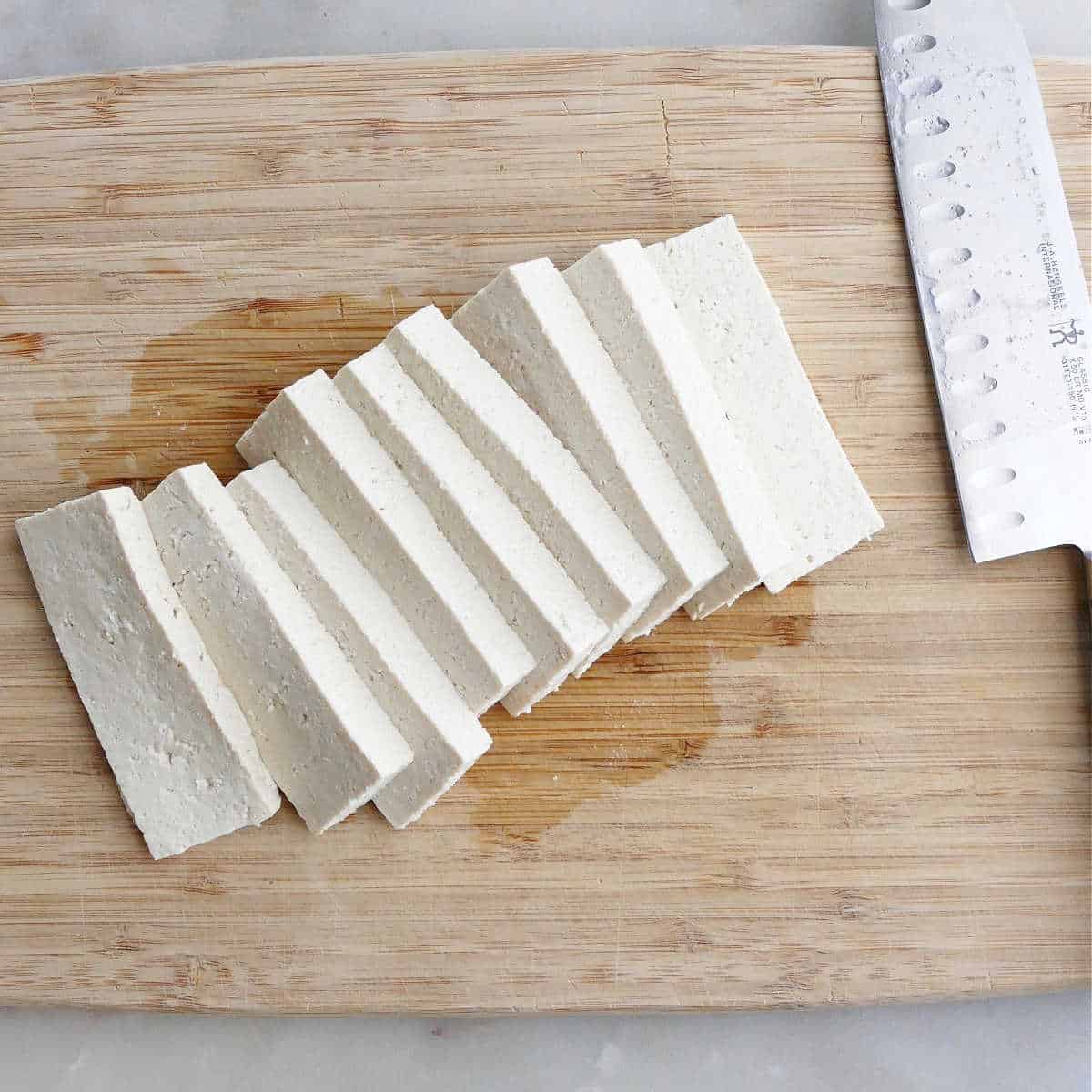 tofu cut into ¼-inch pieces on a cutting board
