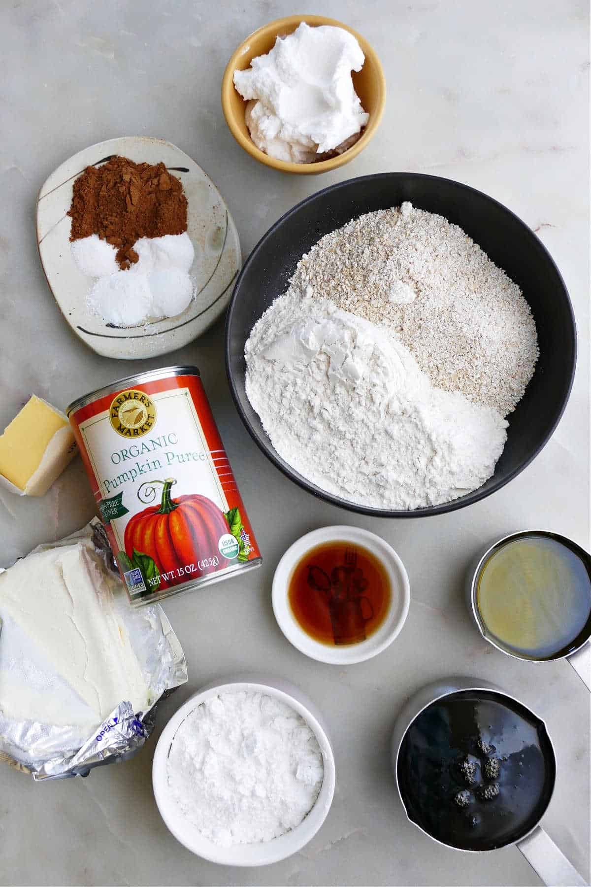 ingredients for pumpkin bars and cream cheese frosting on a counter